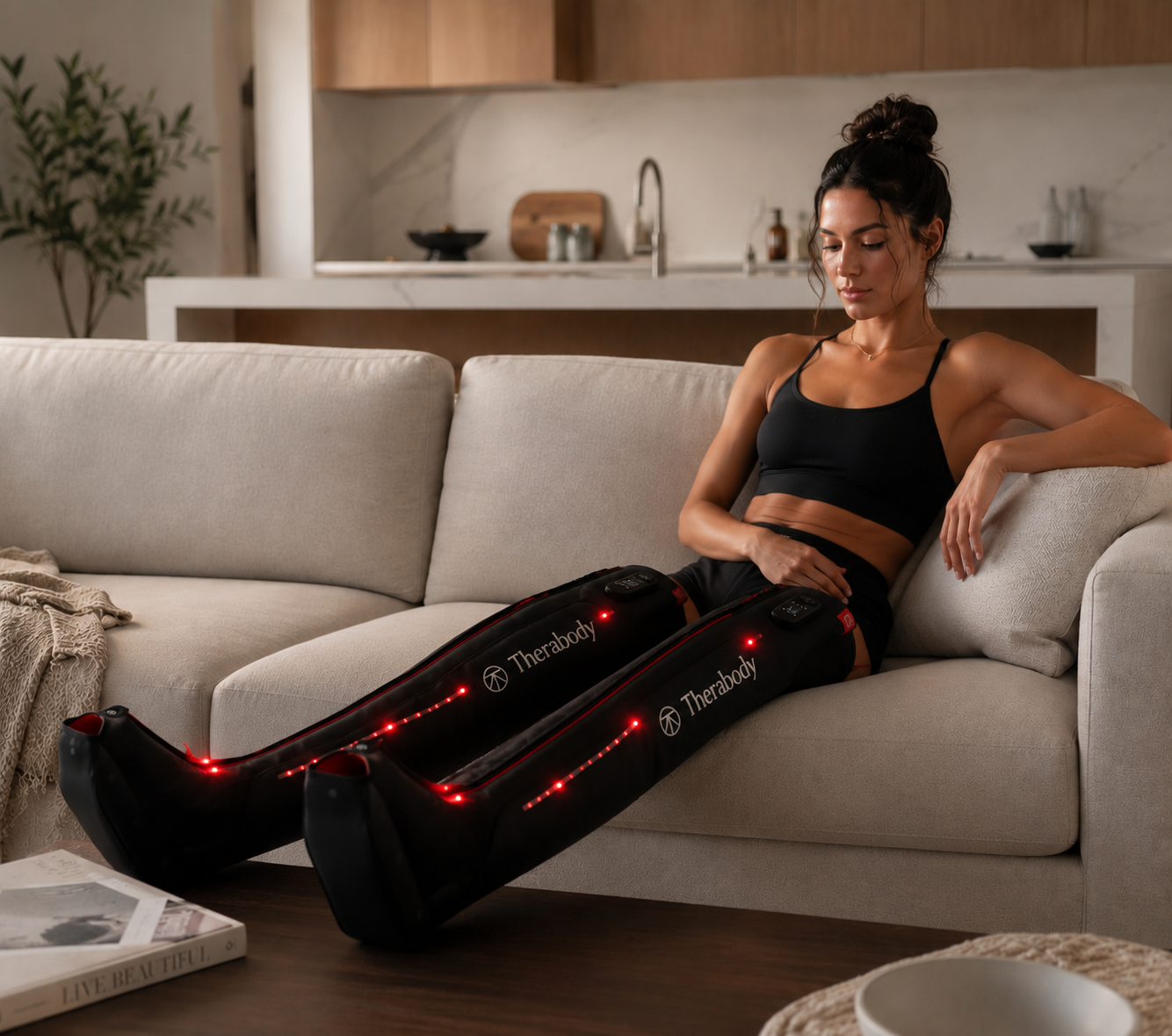 Alt text:
Athlete relaxing on a couch while wearing Therabody JetBoots PRO Plus recovery boots