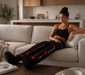 Alt text:
Athlete relaxing on a couch while wearing Therabody JetBoots PRO Plus recovery boots