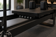 Close up of the carriage rails and rolling mechanism on a black Corextreme Pilates reformer in a modern gym