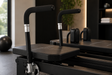 Close up of black padded handles on a Corextreme style Pilates reformer in a modern home gym setting