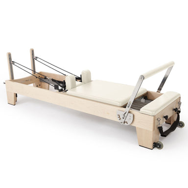 Elina Pilates Elite Wood Reformer Bundle in Solid Rock Maple, featuring a stackable commercial-grade frame with 6-spring resistance and an ultra-quiet carriage, official authorized dealer The Kind Motion.