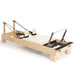Elina Pilates Wooden Reformer Bundle in rock maple featuring an ultra-silent carriage and adjustable height pulleys. Includes jump board and box. Official authorized dealer The Kind Motion.