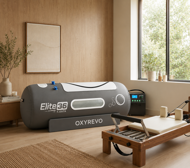 Elite 36 hyperbaric chamber in a luxury modern home wellness space beside a Pilates reformer with warm natural lighting and minimalist decor.