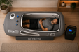 Man relaxing inside the Elite 36 hyperbaric chamber in a modern luxury wellness room showing spacious interior comfort.